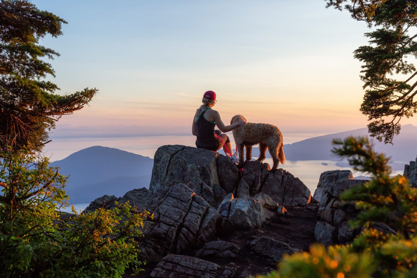Adventurous Girl is hiking with a dog on top of St. Mark's Mountain during a sunny summer sunset. Located in West Vancouver, British Columbia, Canada. See more great instagram captions for summer