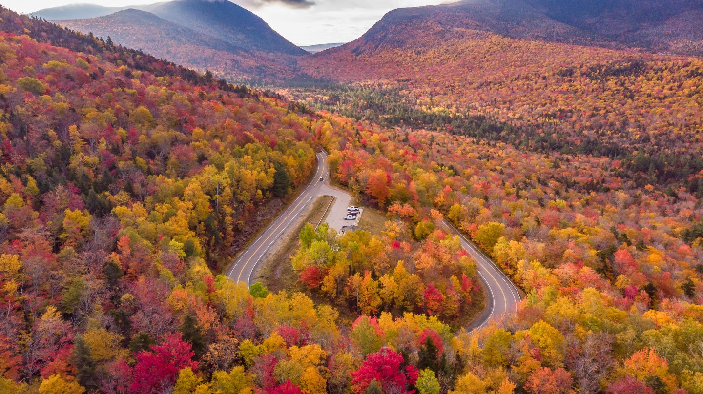 Amazing view of the Kancamagus Highway in New Hampshire during Foliage season in Autumn - one of the popular road trips destinations in North America