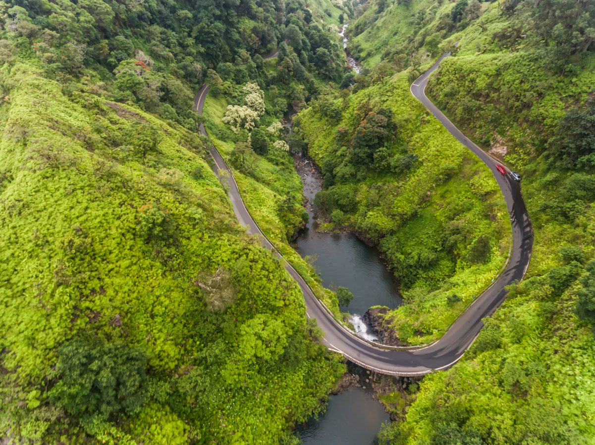 Aerial view of a waterfall on the Road to Hana in Maui, Hawaii - one of the awesome road trips you can go on.
