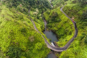 Aerial view of a waterfall on the Road to Hana in Maui, Hawaii - one of the awesome road trips you can go on.