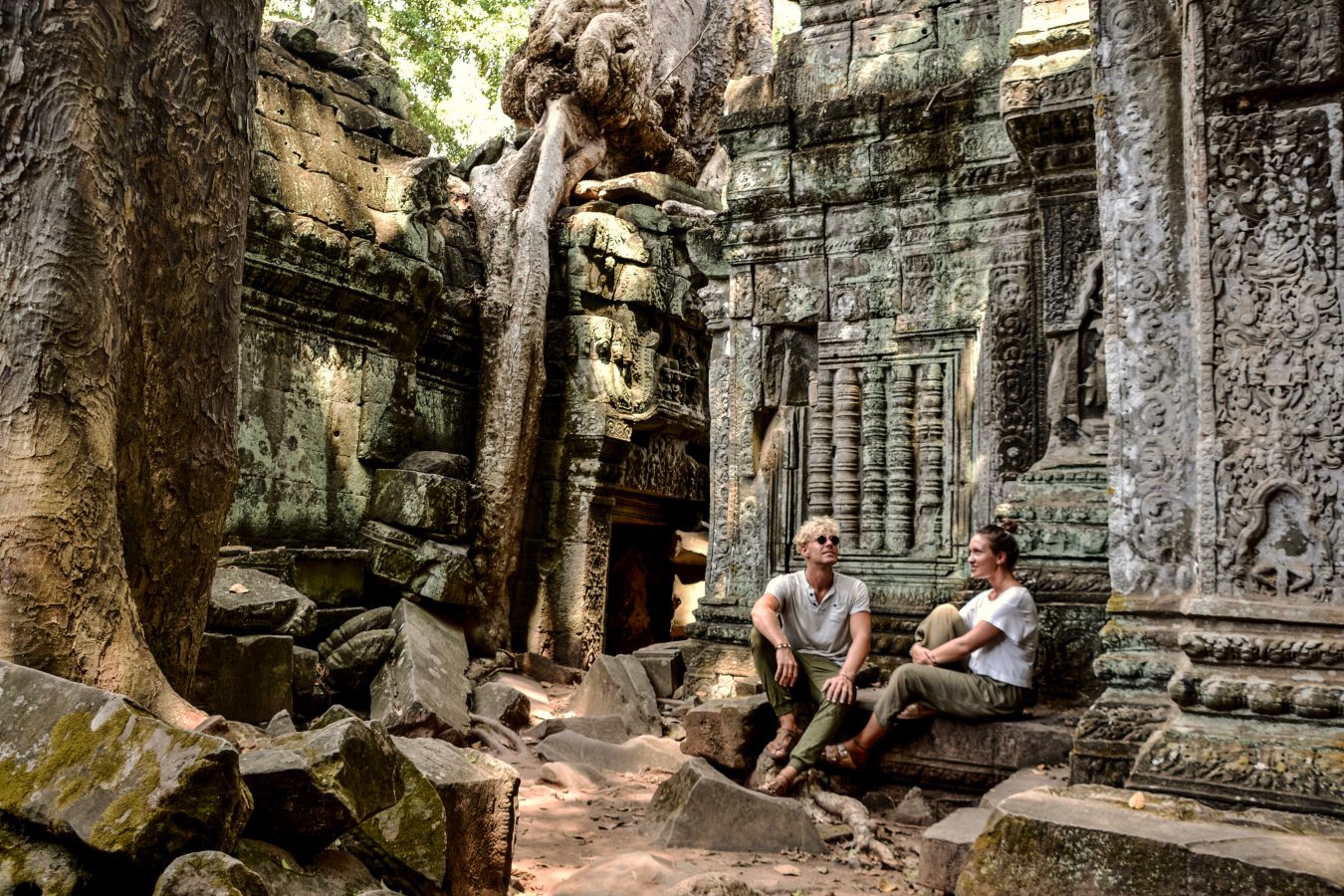 Two travelers sit in Angkor Wat in Siem Reap, Cambodia